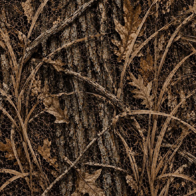 A close-up of a woodland camouflage pattern featuring textured tree bark, dry leaves, and grasses in shades of brown, tan, and dark gray.